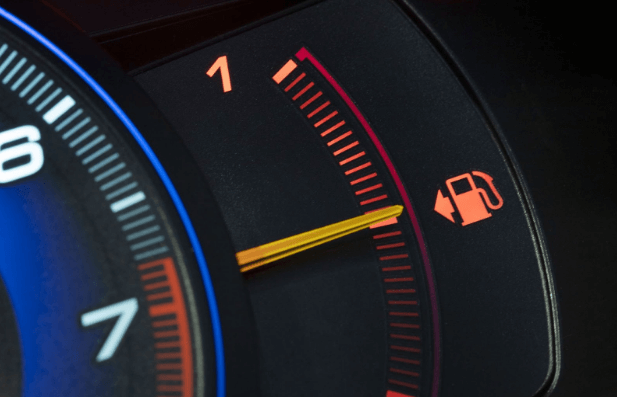 Low fuel warning sign alerting drivers they’re running low on fuel