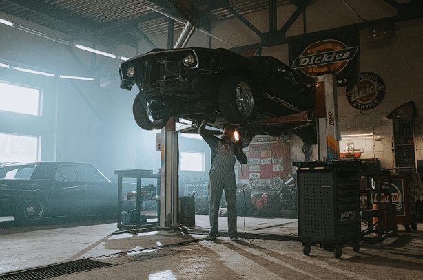 A professional mechanic performing a transmission fluid change.