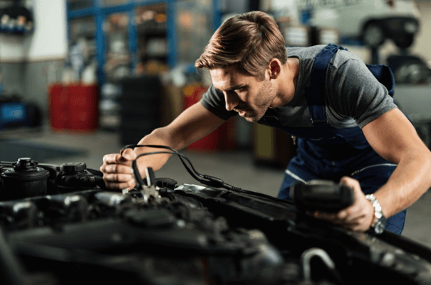 A mechanic replacing worn-out parts with quality used car parts