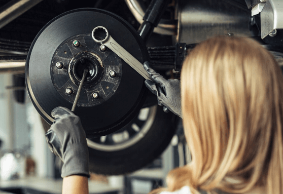 used car parts supplier working on a vehicle wheel